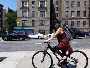 Man riding bicycle on street in city