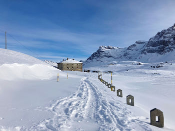 Snow covered mountain against blue sky