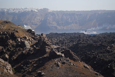 Scenic view of land and mountains against sky
