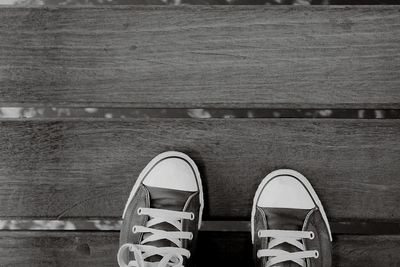 Low section of woman standing on tiled floor