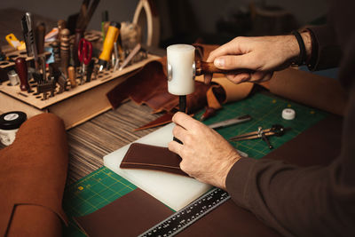 Midsection of man working on table