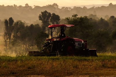 Tractor on field against sky