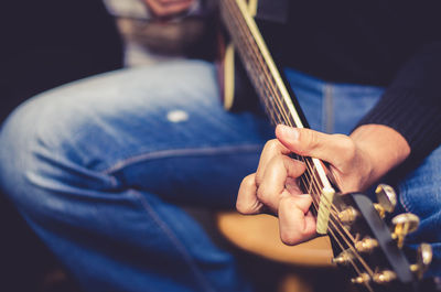 Close-up of man playing guitar