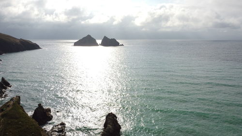 Scenic view of rocks in sea against sky