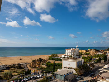 High angle view of buildings by sea against sky