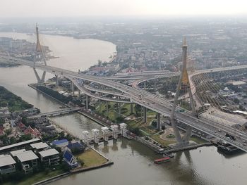 High angle view of illuminated city at riverbank