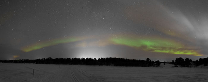 Scenic view of landscape against sky at night during winter