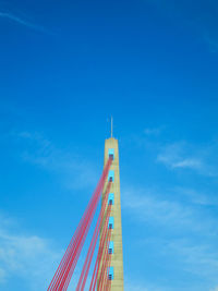 Low-angle view of fleher brücke in düsseldorf against blue sky 