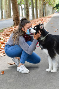 Woman with dog sitting outdoors