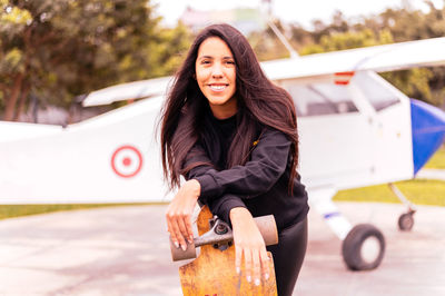 Portrait of smiling young woman sitting on table