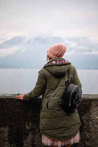 Rear view of woman looking at sea against sky