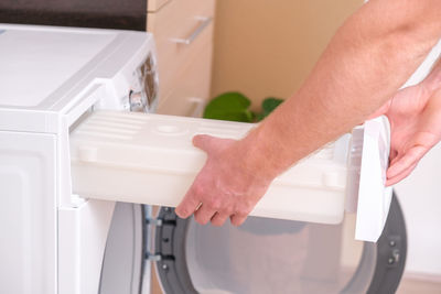 Cropped hands of man working at home