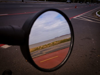 Reflection of landscape in round mirror