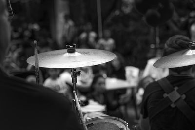 Cropped image of musician playing cymbals at music concert