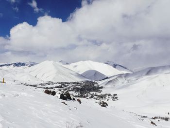 Scenic view of snow covered mountains against sky