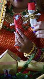 Midsection of woman holding christmas decorations