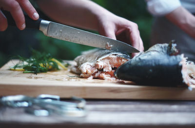 Close-up of man preparing food on cutting board