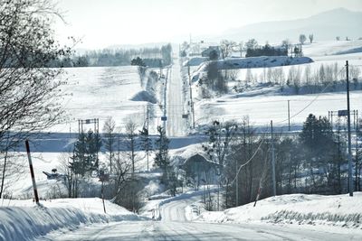 Snow covered landscape against sky