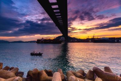 View of bridge over sea during sunset