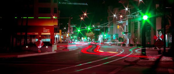 Panoramic view of city street at night