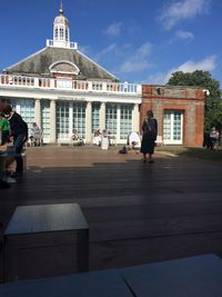People in front of building against sky