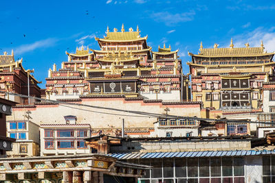 Buildings in city against sky