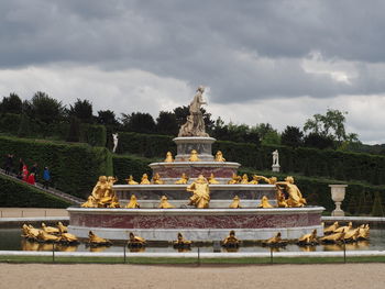 Statue of temple against cloudy sky