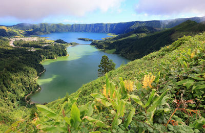 Scenic view of green mountains against sky