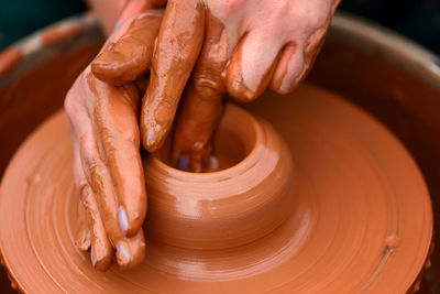 Hands of a potter. potter making ceramic pot on the pottery wheel