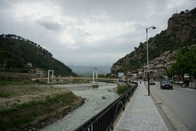 Street amidst mountains against sky