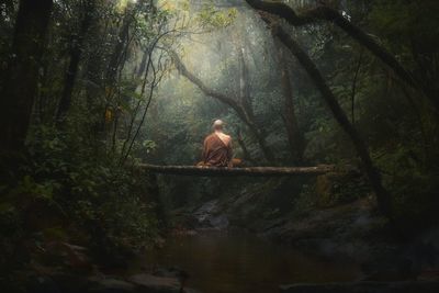 Man sitting in forest