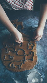 High angle view of person preparing cookies on table