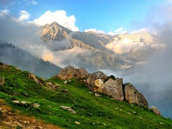 Scenic view of mountains against cloudy sky