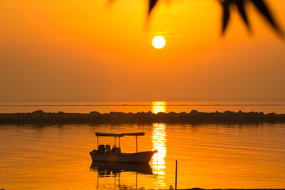 Scenic view of sea against orange sky during sunset