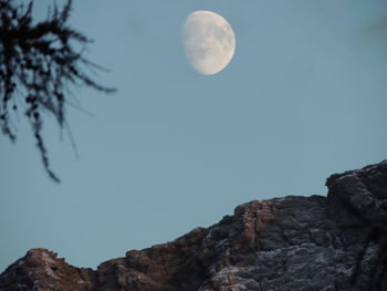 Low angle view of moon in sky at night