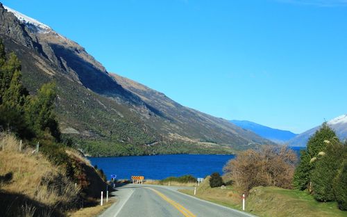 Scenic view of mountains against clear blue sky