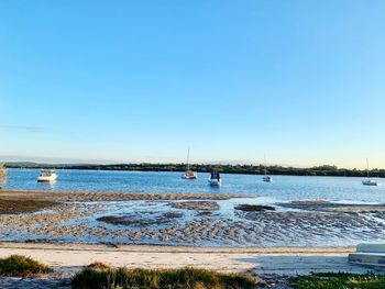 Scenic view of sea against clear blue sky