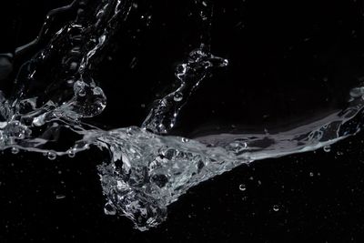 Close-up of water splashing against black background