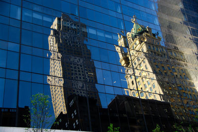 Low angle view of modern building against blue sky