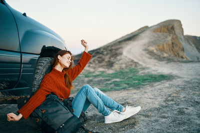 Young woman sitting in car