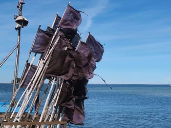 Sailboat by sea against sky
