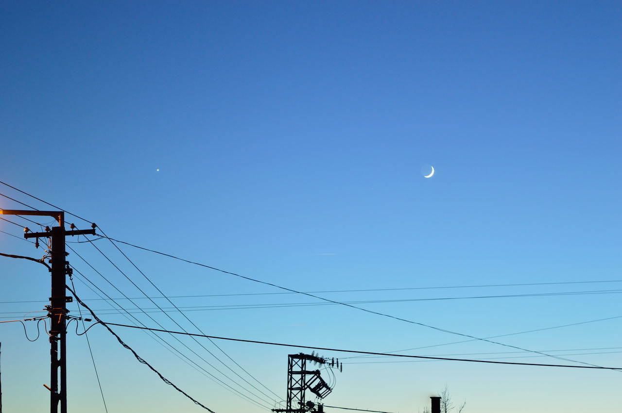 LOW ANGLE VIEW OF POWER LINES AGAINST CLEAR BLUE SKY