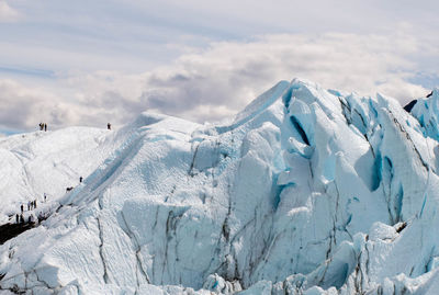 Scenic view of snow covered mountains against sky