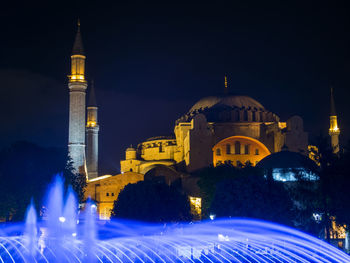 Blue illuminated fountain against hagia sofia