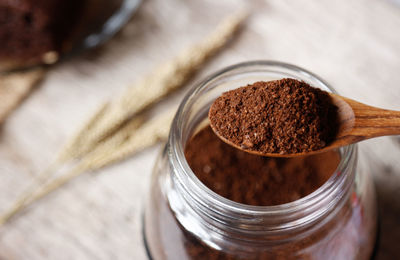 High angle view of ground coffee in jar on table