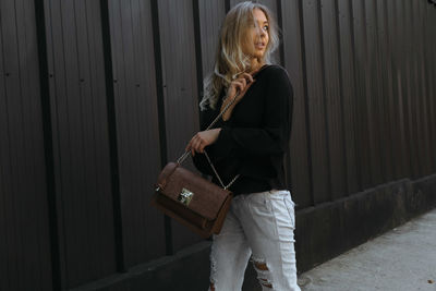 Woman standing against wall