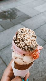 Close-up of hand holding ice cream cone