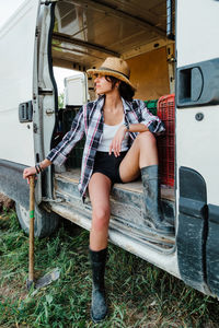 Full length of woman sitting in motor home