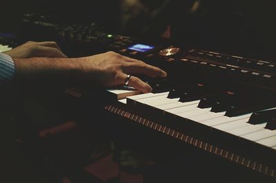 Close-up of man playing piano