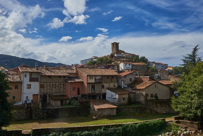 Buildings in town against sky